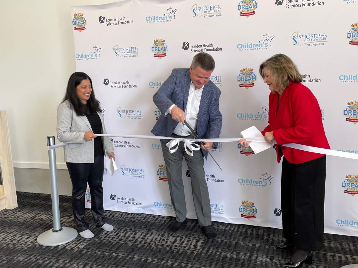 Left to right, Farah Rohoman, John MacFarlane and Michelle Campbell cut the ribbon to kick off the dream home lottery on April 6, 2023.
