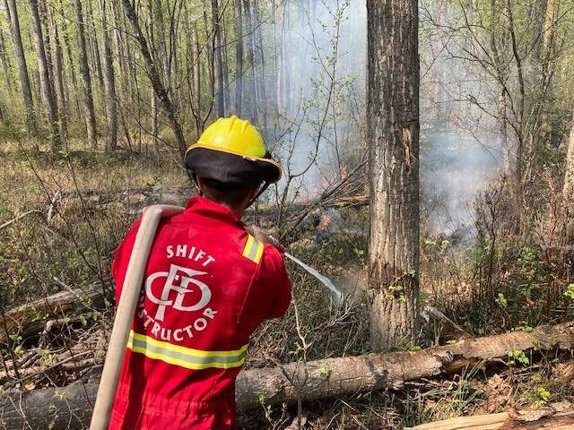 Fire crews battle the Dunes West wildfire near Grande Prairie, Alberta, on May 11, 2023.