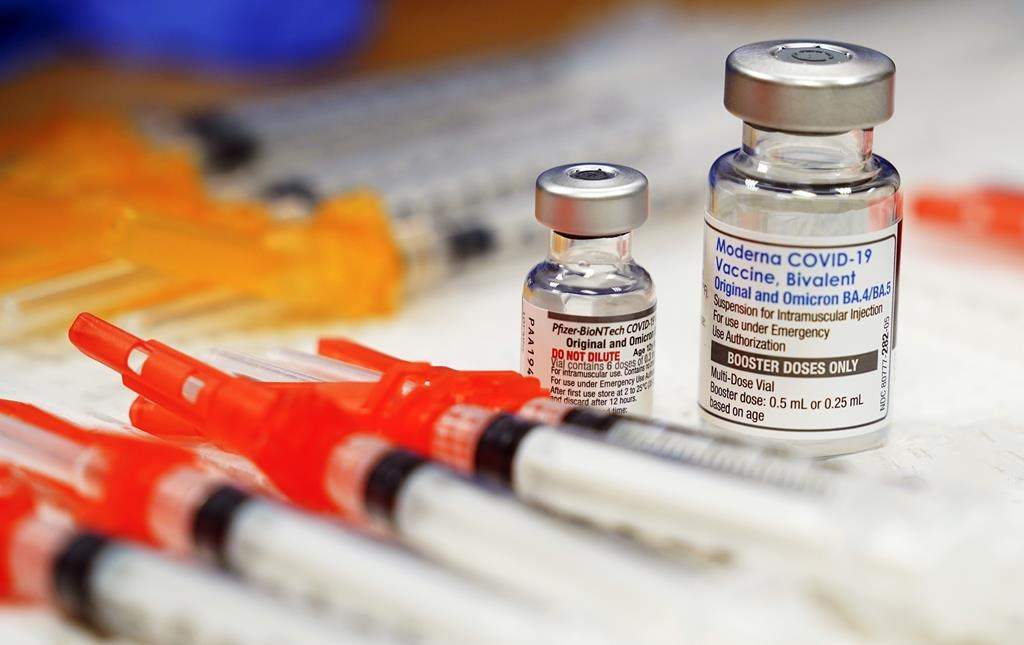 FILE - Pfizer, left, and Moderna bivalent COVID-19 vaccines are readied for use at a clinic, Nov. 17, 2022, in Richmond, Va. The Biden administration will end most of the last remaining federal COVID-19 vaccine requirements next week when the national public health emergency for the coronavirus ends, the White House said Monday, May 1, 2023. (AP Photo/Steve Helber, File).