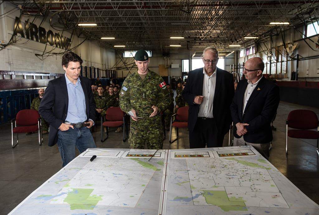 Prime Minister Justin Trudeau (left to right), Colonel Ben Schmidt, MP Randy Boissonnault, and MP Bill Blair meet with members of the Canadian Armed Forces who are assisting in the Alberta wildfires, in Edmonton on Monday May 15, 2023. THE CANADIAN PRESS/Jason Franson