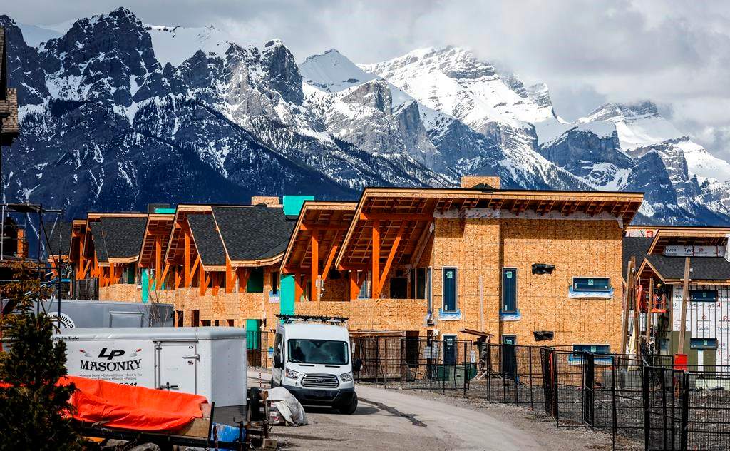 Mt. Rundle rises behind homes being constructed in Canmore, Alta., Monday, April 24, 2023.