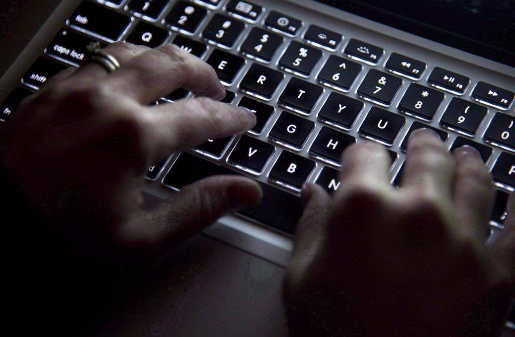 Hands on a keyboard type in North Vancouver, B.C., on December 19, 2012.