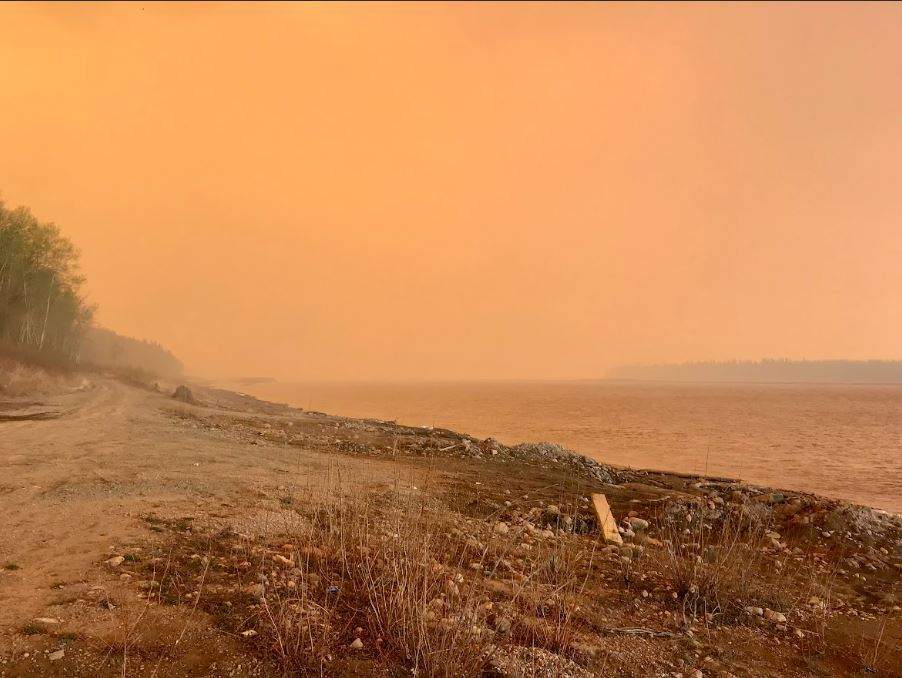 Orange skies near Fox Lake in northern Alberta as an out-of-control wildfire threatens the community.