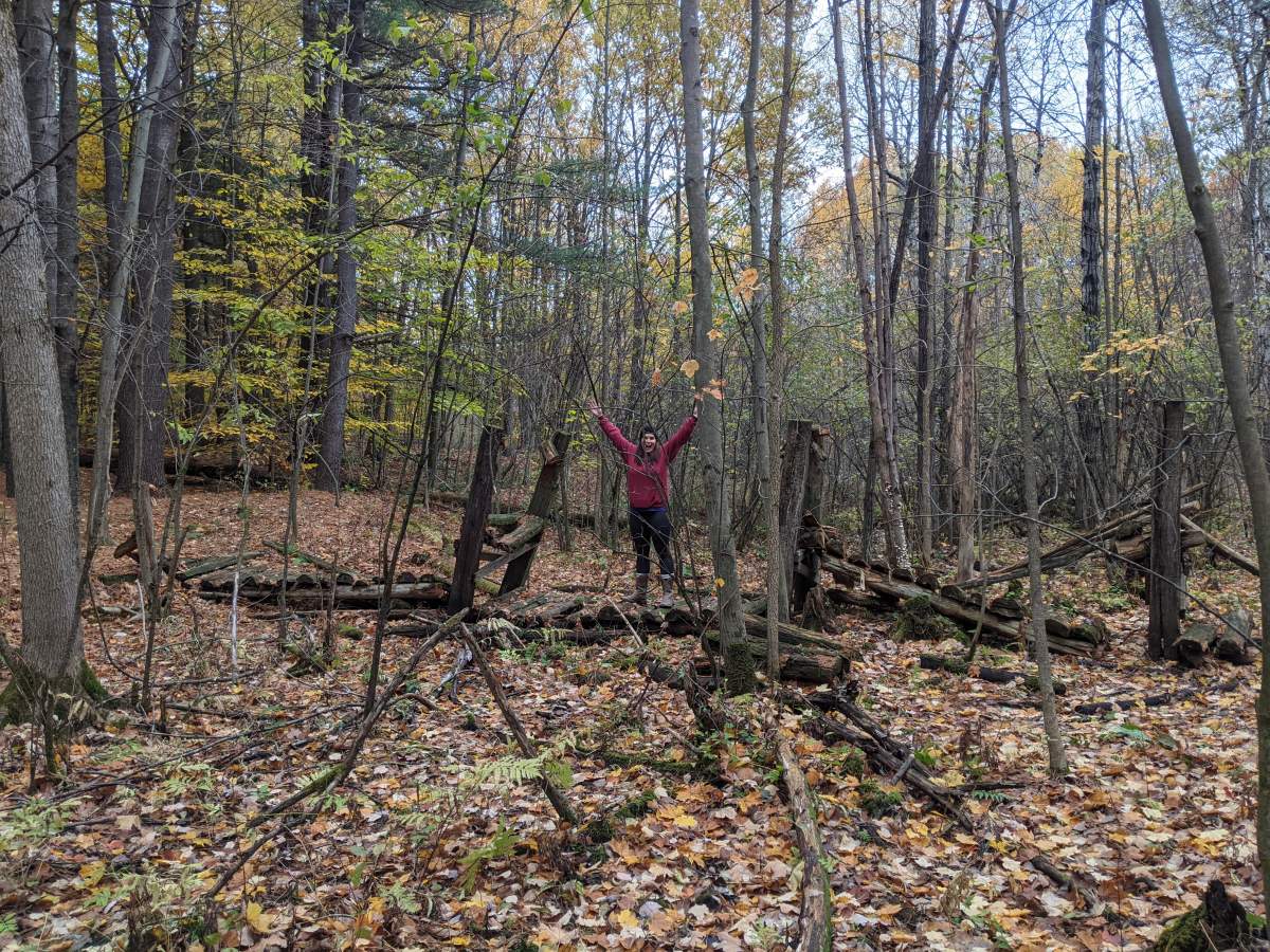 Malyssa Houle stands where the old footbridge is at Dunn Memorial Scout Camp.