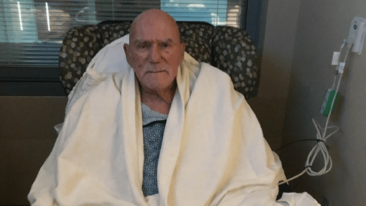 'Superstar' Billy Graham in a blanket, sitting in a chair.