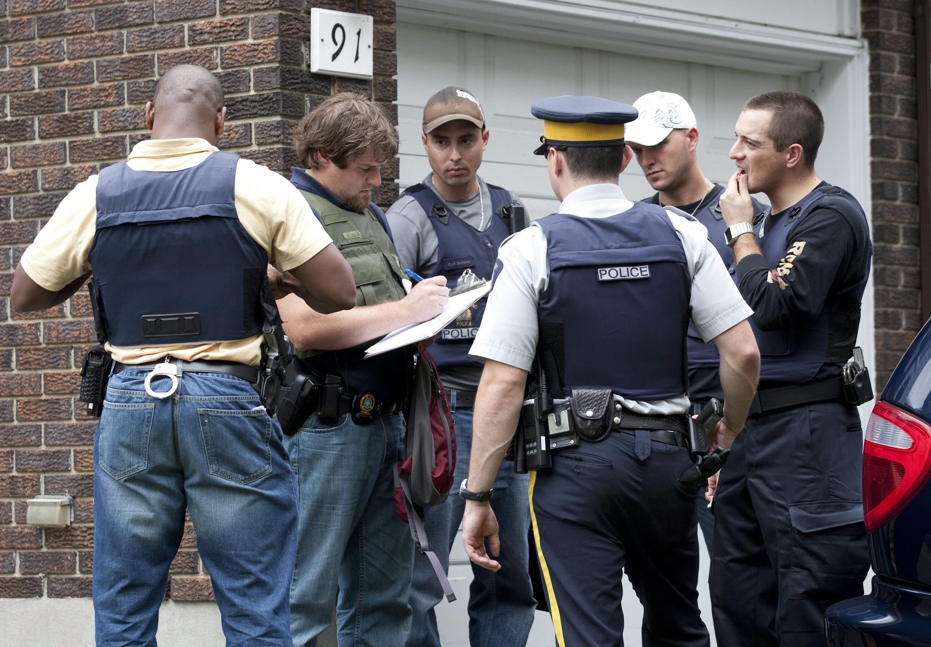 Police search Ottawa home following 2010 arrest of Hiva Alizadeh. THE CANADIAN PRESS/Adrian Wyld.