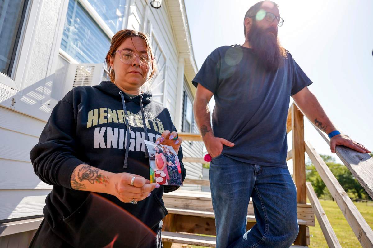 Ashleigh Webster shows a photo of Ivy Webster and Tiffany Guess at her home in Henryetta, Okla., Tuesday, May 2, 2023.