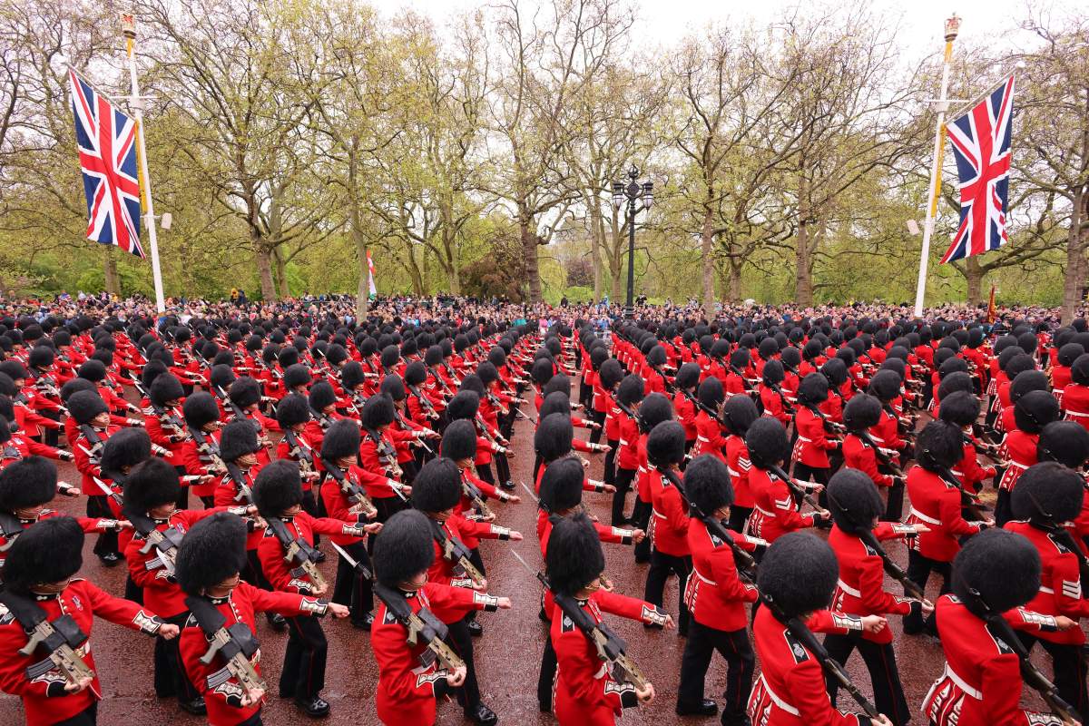 Coldstream Guards stand to attention along The Mall ahead of the Coronation of King Charles III and Queen Camilla in London, Saturday, May 6, 2023. (Richard Heathcote, Pool via AP)