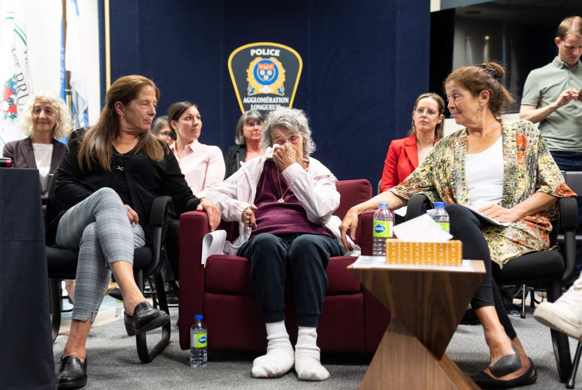 Yvonne Prior, centre, reacts with her daughters Moreen, left and Doreen during a press conference as police confirm the identity of the killer of the 1975 murder of her daughter Sharron on Tuesday, May 23, 2023 in Longueuil, Que.