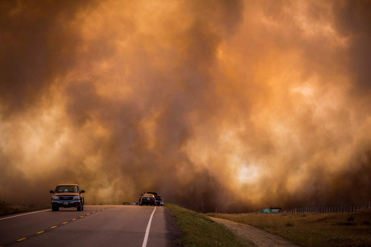 Grass fire and smoke stop traffic on Highway 509 on the Blood Reserve west of Lethbridge, Alberta on Sept. 10, 2012.