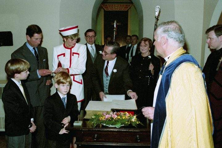Their Royal Highnesses the Prince and Princess of Wales, Prince William and Prince Harry add their names to a Bible reserved for official visits at St. James Anglican Cathedral while attending Sunday service at the church during their visit to Toronto on Sunday, Oct. 27, 1991. From left are Prince William, Prince Charles, Prince Harry, Princess Diana, Edwin Hawken, warden, Andy Ritchie, sidesman, Barbara Hawkins, warden, The Very Rev. Duncan Abraham, dean and Paul Seddon, verger.