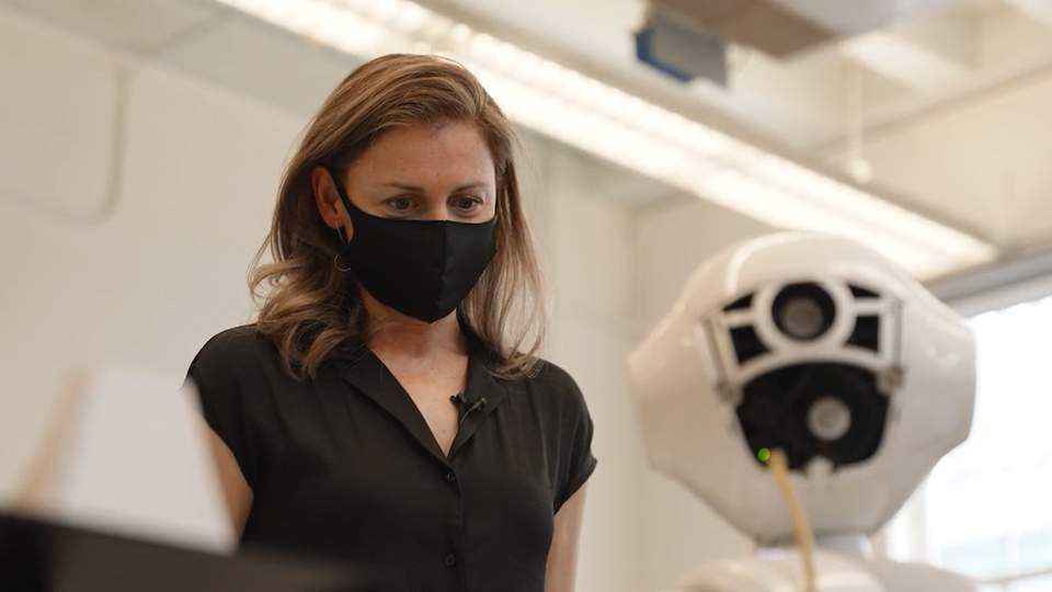 PhD canidate Cristina Getson showing how Pepper, the health-screen robot, works