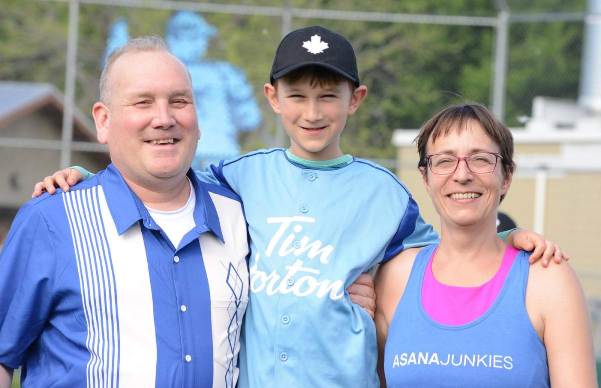 Jerome Abraham, former executive director of Discovery House men’s recovery centres, with his son Leif, 8, and partner Kassandra at a ball practice this week.