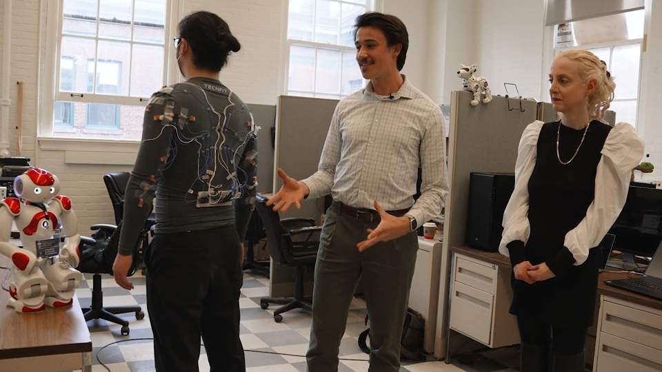 Masters students, Fraser Robinson and Zinan Cen, demoing their smart clothing wearable for older adults