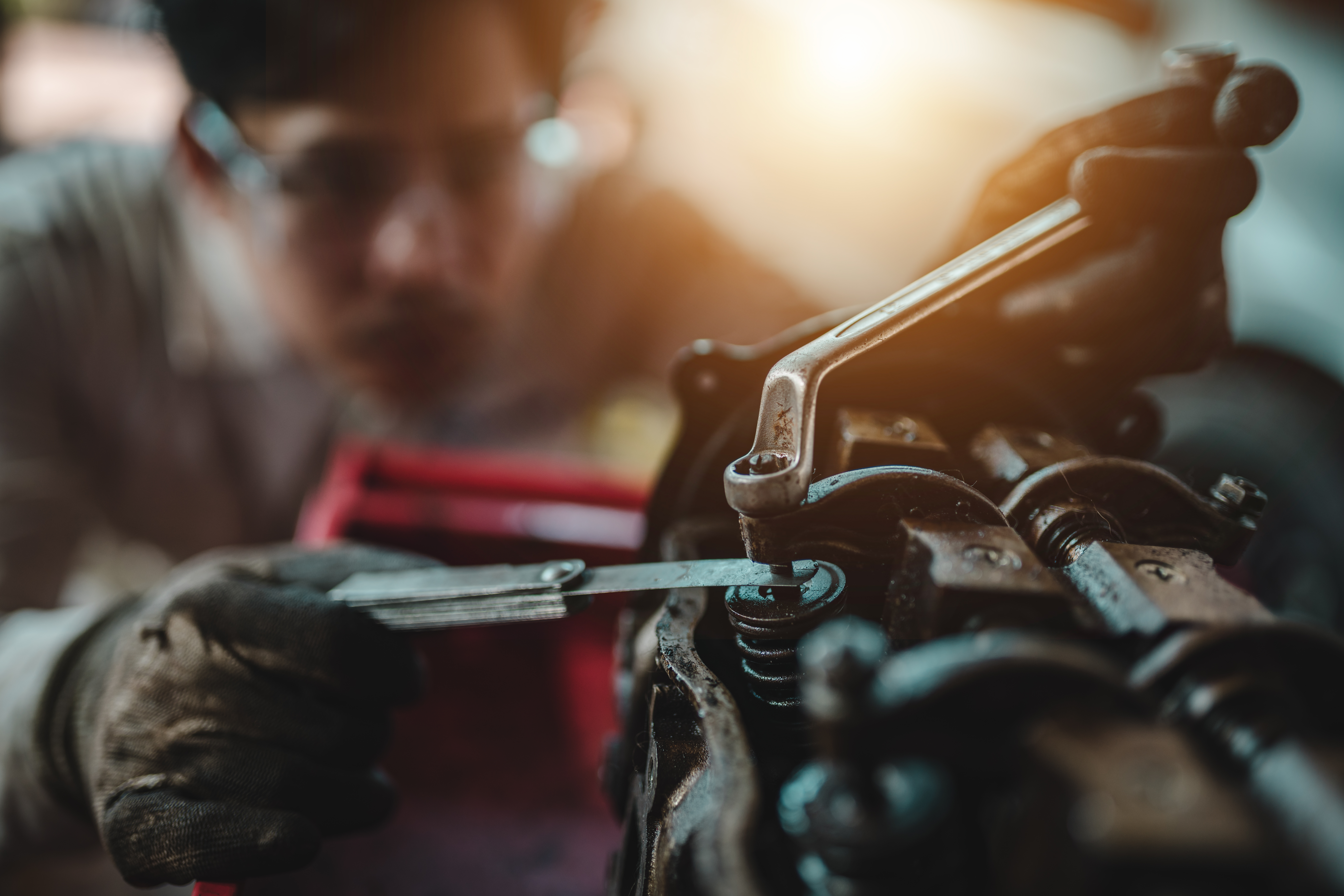 Automotive technicians. Setting the valve for the car in the garage.