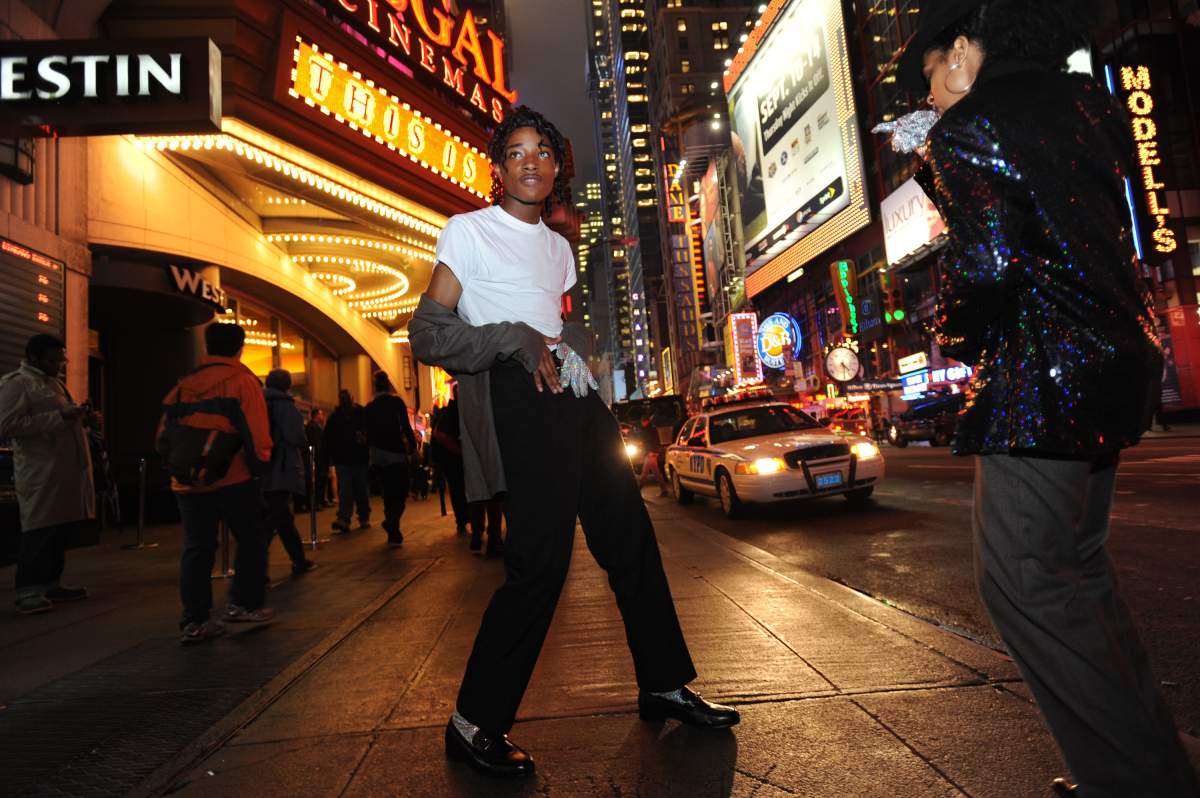 Jordan Neely in white shirt and black trousers He is posed like Michael Jackson.