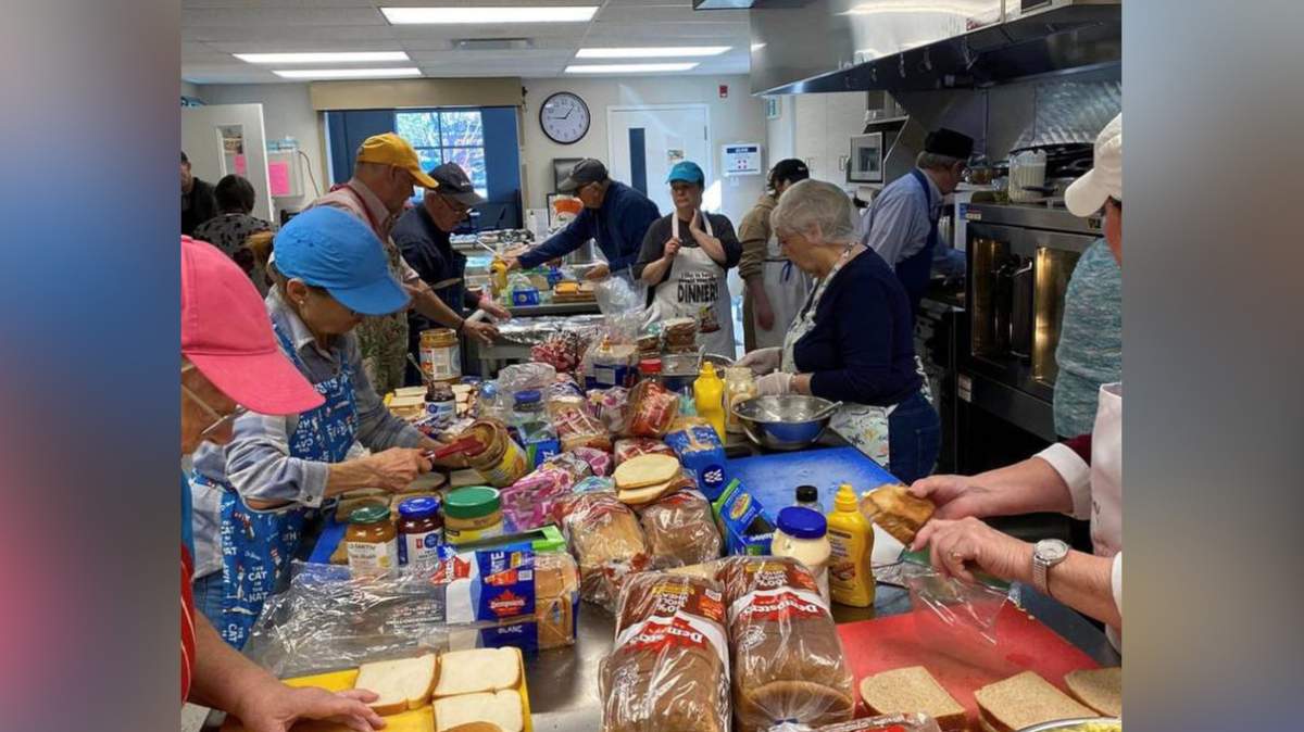 A photo of volunteers preparing food for a Gore Park Outreach event in Hamilton, Ont.
