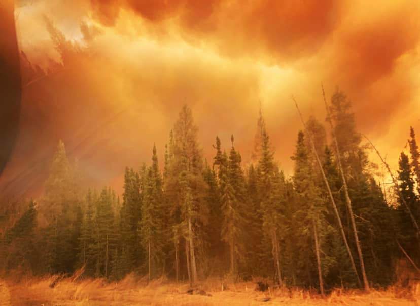 Smoke fills the sky near a wildfire in northern Alberta that forced residents of Fox Lake to flee.