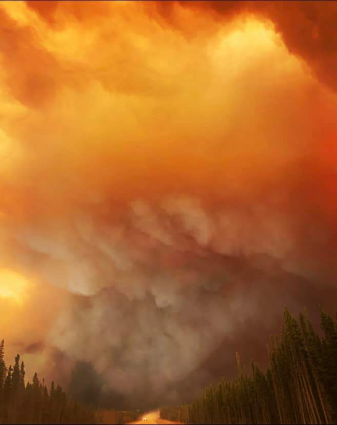 Smoke fills the sky near a wildfire in northern Alberta that forced residents of Fox Lake to flee.