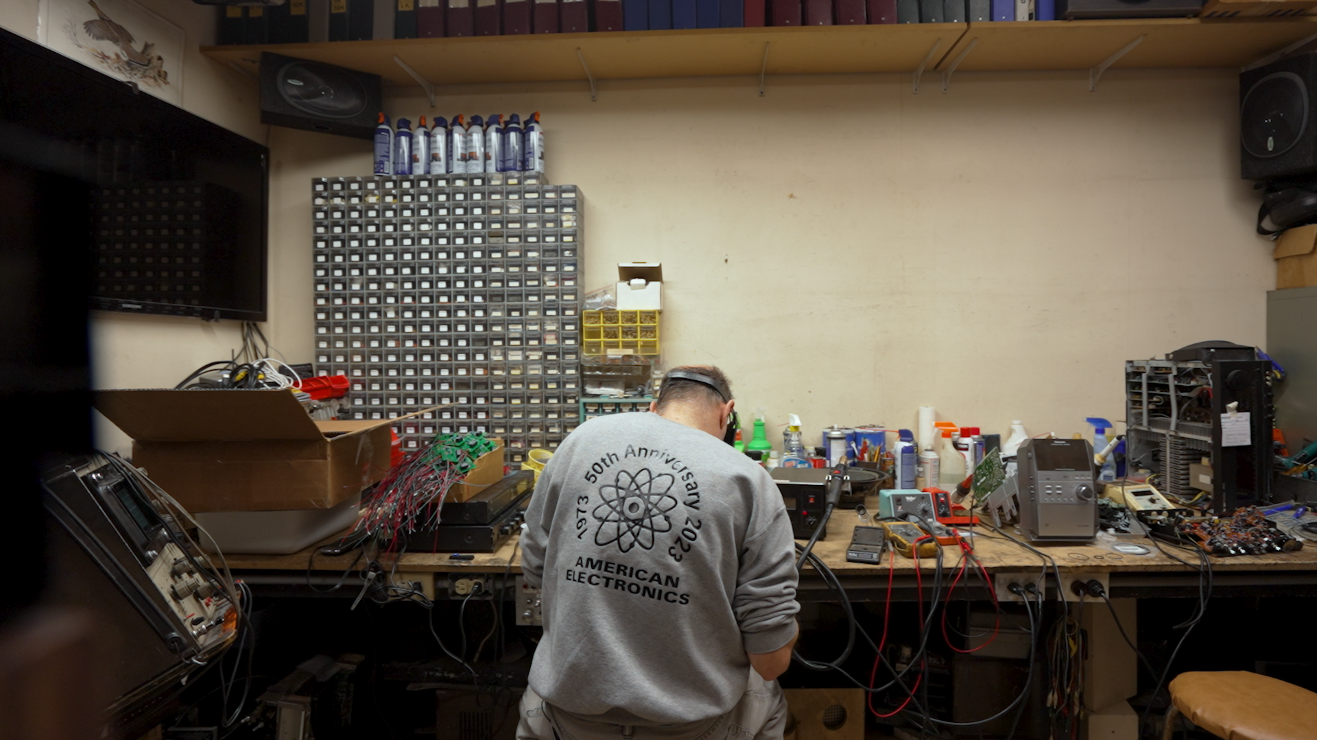 John Fadel works away at his repair shop, American Electronics.