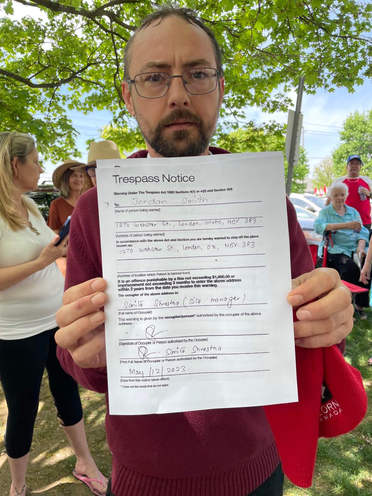 A man holding a trespass notice.