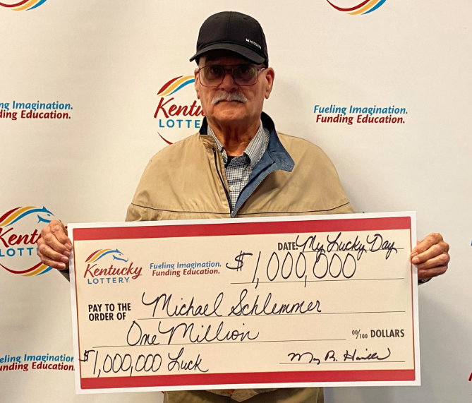 Michael Schlemmer holding a $1 million cheque.