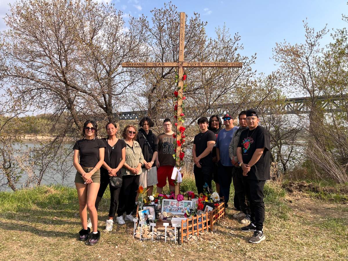 Nathaniel Bear’s family stands beside a new memorial.