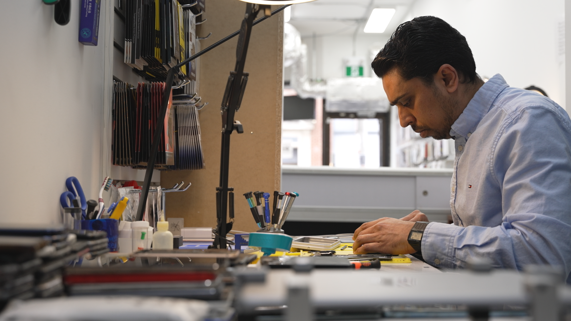 Repair technician Rayhan Mohammed Siraj fixes smartphones at his shop, Phone Solutions in Toronto, Ont.