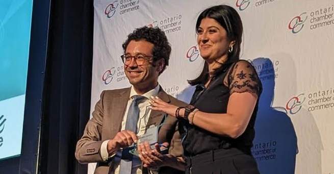 Guelph chamber CEO Shakiba Shayani (right) receives the Burnie Gillespie Memorial Award at the OCC annual general meeting in Niagara Falls.