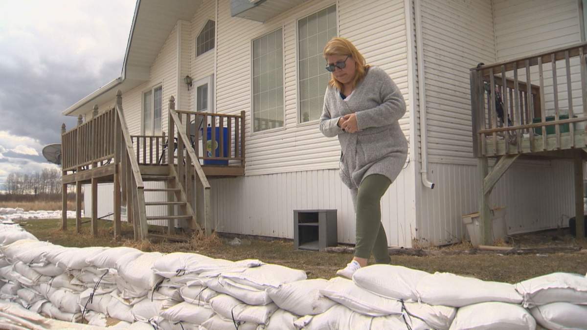 Carol Spence assesses sandbags in front of her home on Peguis First Nation. While the community didn’t flood this year, she had sandbags put in as a precaution, as her home has had significant flooding in the past.