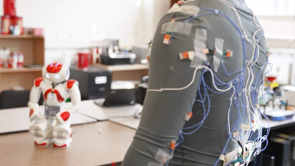 Zinan Cen showing us the wires on the back of his smart clothing wearable for older adults