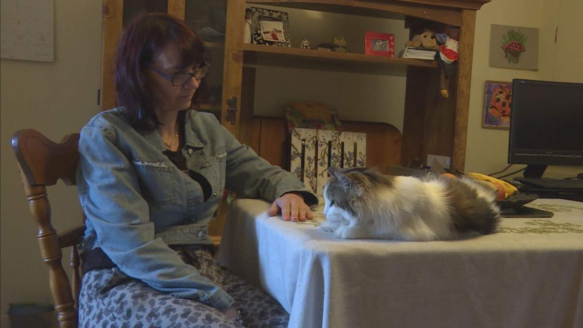 Tricia Bartley and Lola, her 20-year-old cat.