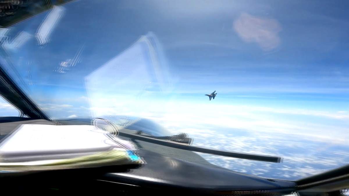 In this image from video provided by the U.S. Navy, a Chinese J-16 fighter flys aggressively close to a U.S. RC-135 aircraft flying in international airspace over the South China Sea on Friday, May 26, 2023. In a statement, U.S. Indo-Pacific Command said the Chinese J-16 fighter pilot “flew directly in front of the nose of the RC-135.” It called the Chinese move an ” unnecessarily aggressive maneuver.” (U.S. Navy via AP)