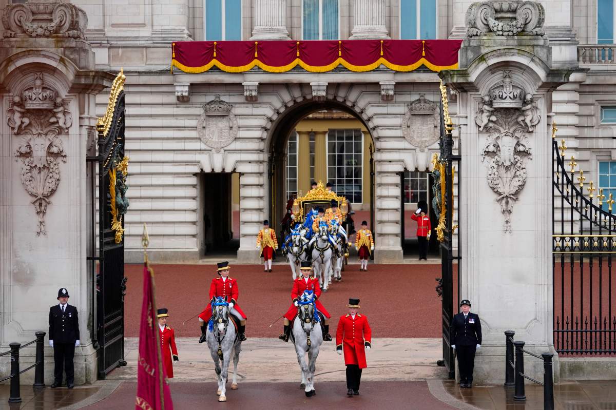 The gilded carriage carrying King Charles and Camilla leaves Buckingham Palace.