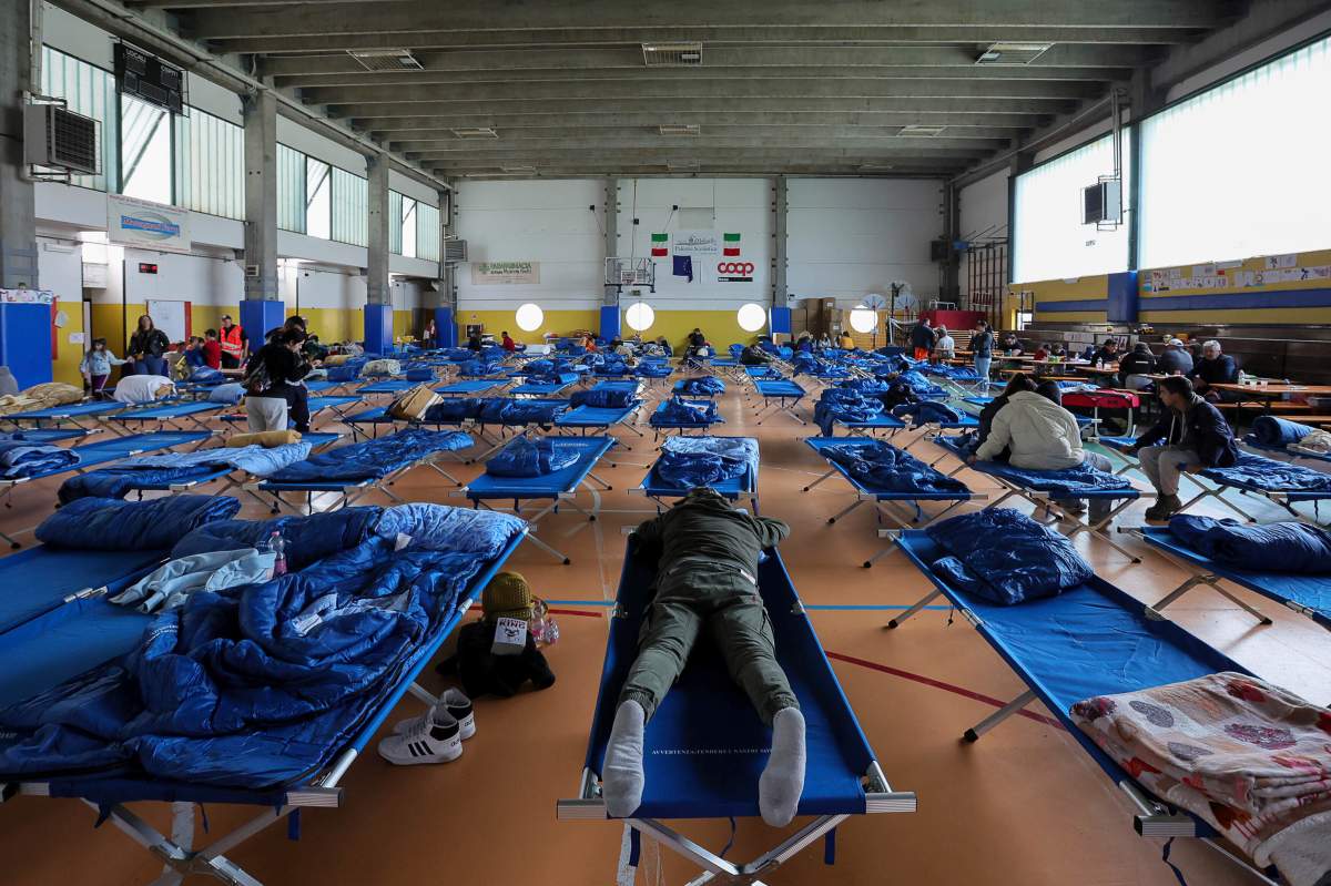 Evacuees rest in a gymnasium in Bologna, Italy, Thursday, May 18, 2023. (Guido Calamosca/LaPresse via AP)