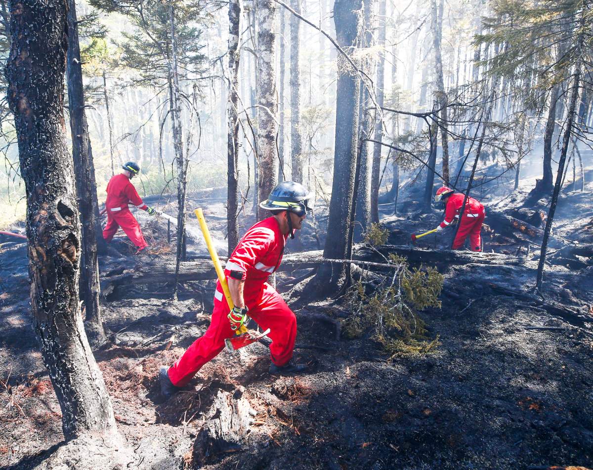 Three firefighters with Halifax Regional Fire and Emergency work to put out fires in the Tantallon area.