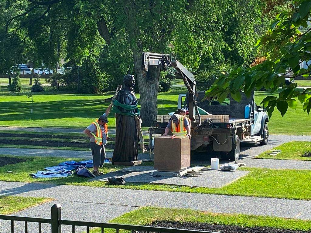 Workers reinstall a statue of Queen Elizabeth that was toppled on Canada Day 2021 on the grounds of the Manitoba legislature in Winnipeg on Friday June 2, 2023. 
