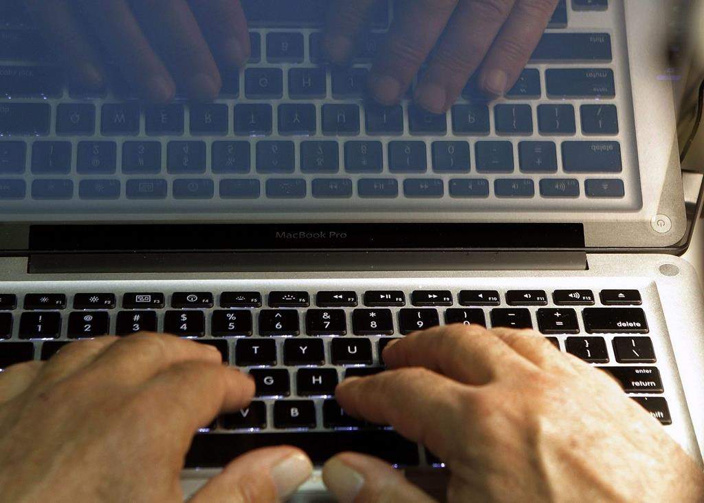 hands on a computer keyboard.