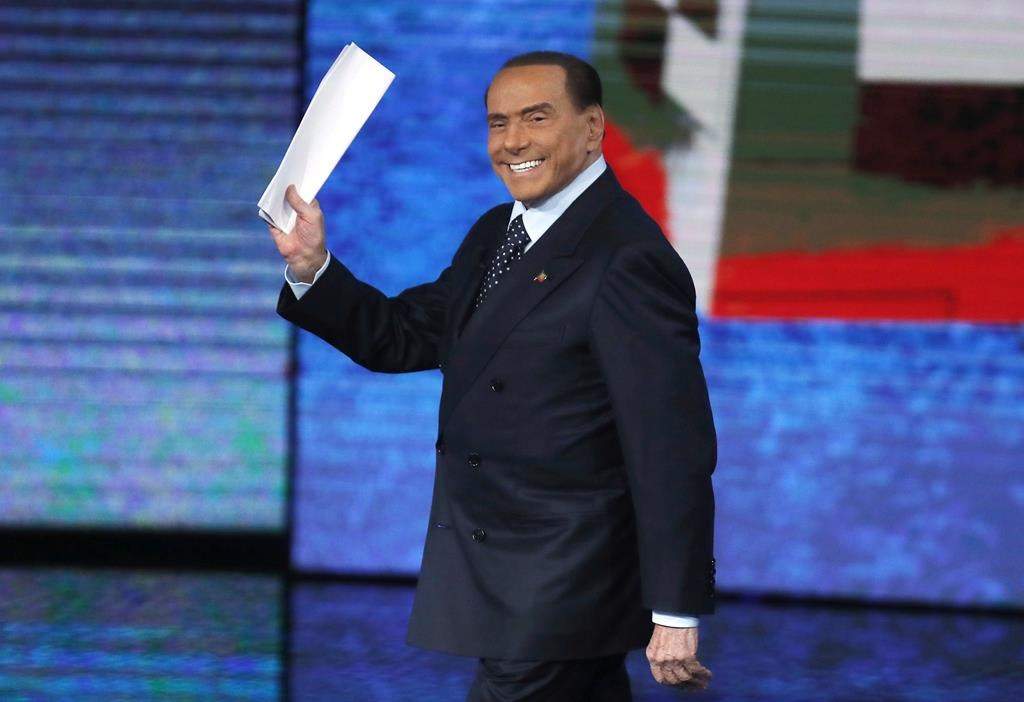 FILE – Former Italian premier Silvio Berlusconi waves as he arrives for the Italian State RAI TV program “Che Tempo che Fa”, in Milan, Italy, on Nov. 26, 2017.