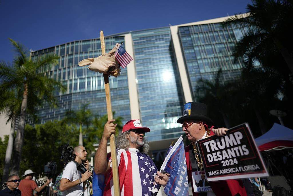 Osmany Estrada and Gregg Donovan, rally outside the Wilkie D. Ferguson Jr. U.S. Courthouse, Tuesday, June 13, 2023, in Miami. Former President Donald Trump is making a federal court appearance today on dozens of felony charges accusing him of illegally hoarding classified documents and thwarting the Justice Department’s efforts to get the records back. (AP Photo/Rebecca Blackwell)