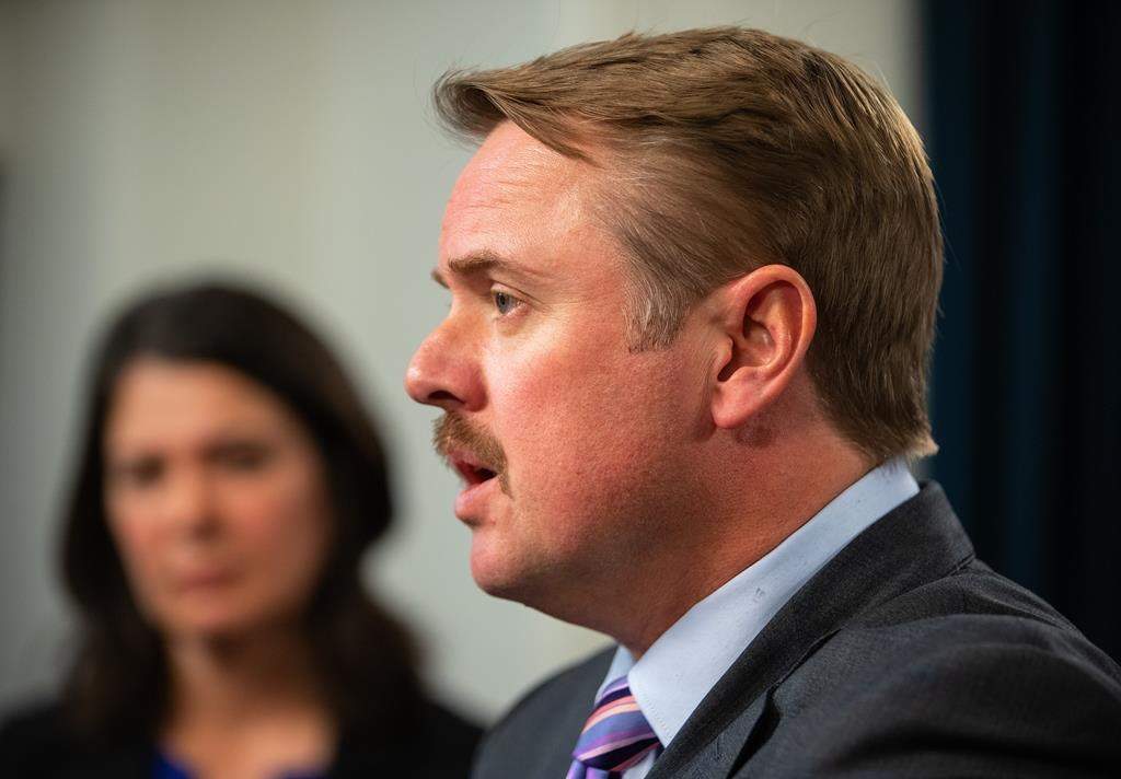 Then-Minister of Justice and Solicitor General of Alberta Tyler Shandro speaks at a press conference after the throne speech in Edmonton, Tuesday, Nov. 29, 2022. A Law Society of Alberta hearing into allegations that the former Alberta cabinet minister broke the lawyers' code of conduct won't hear final arguments before September.
