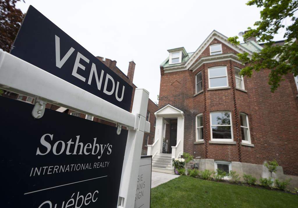 Real estate signage showing a home that has sold is seen on Monday, May 15, 2023 in Montreal. The Canadian Real Estate Association says home sales in May climbed higher compared with the same month last year to post the first year-over-year sales increase since June 2021 as prices also climbed higher.
