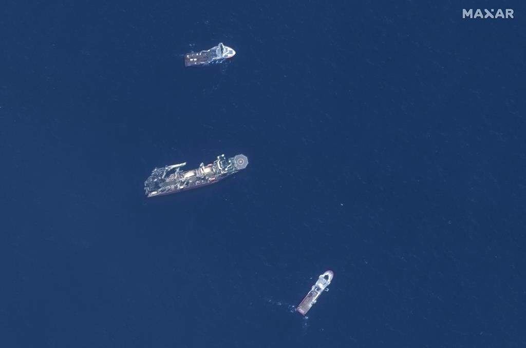 In this satellite image provided by Maxar Technologies, from top to bottom, the vessels Horizon Arctic, Deep Energy and Skandi Vinland search for the missing submersible Titan on June 22 in the Atlantic Ocean.
