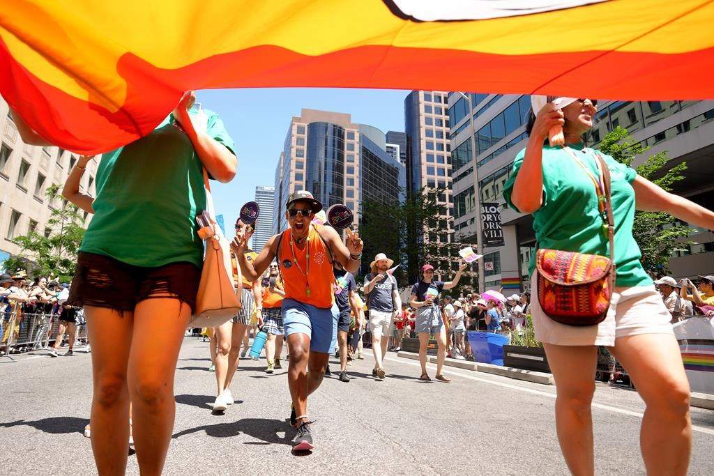 Participants walk in the Toronto Pride Parade, in Toronto, Sunday June 25, 2023.