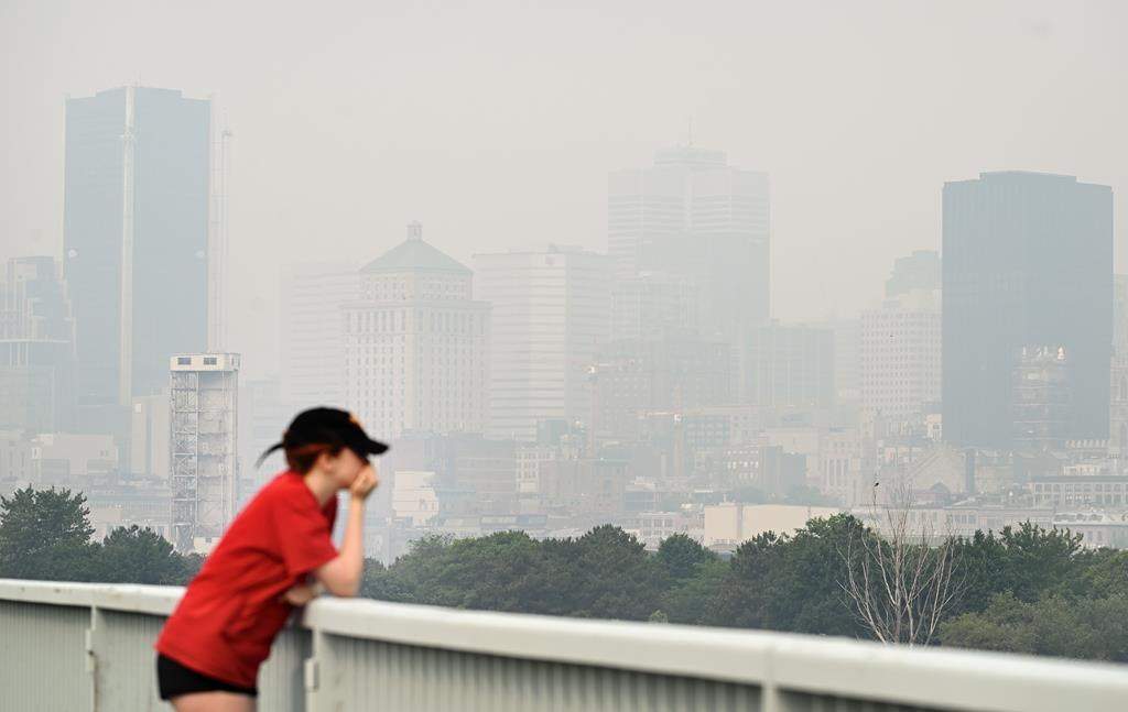 The skyline of Montreal is obscured by a haze of smog, Sunday, June 25, 2023. Smoke from the wildfires burning across northern Quebec is grounding the province’s water bombers and causing widespread smog warnings futher south.