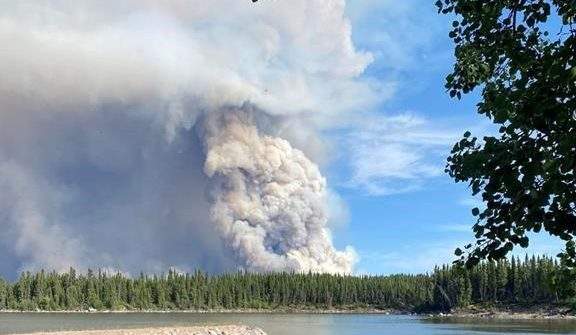 A plume of smoke rises from a wildfire burning near Leaf Rapids, Man., in an undated handout photo. THE CANADIAN PRESS/HO-Dawn Halcrow.