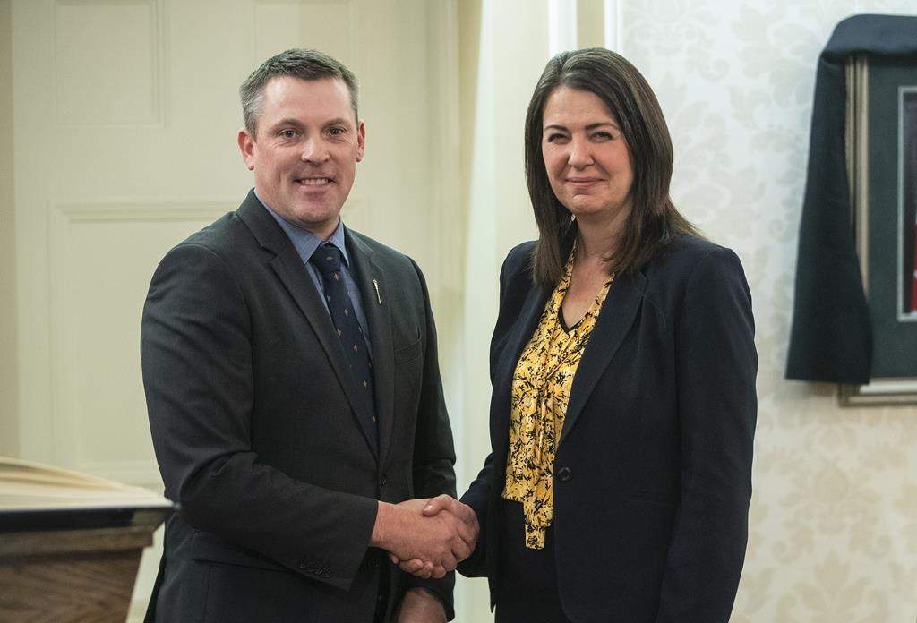 Nate Horner shakes hands with Alberta Premier Danielle Smith after a swearing-in ceremony in Edmonton, Monday, Oct. 24, 2022.