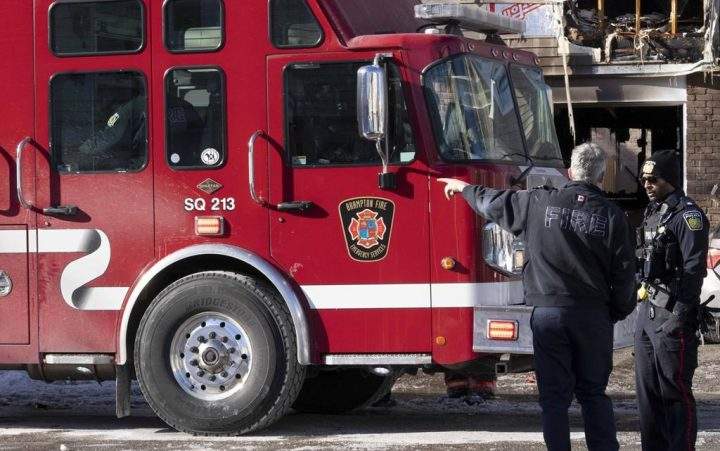 File photo. A fire official and police officer talk at the scene of a fatal house fire in Brampton, Ont., Thursday, Jan.20, 2022.