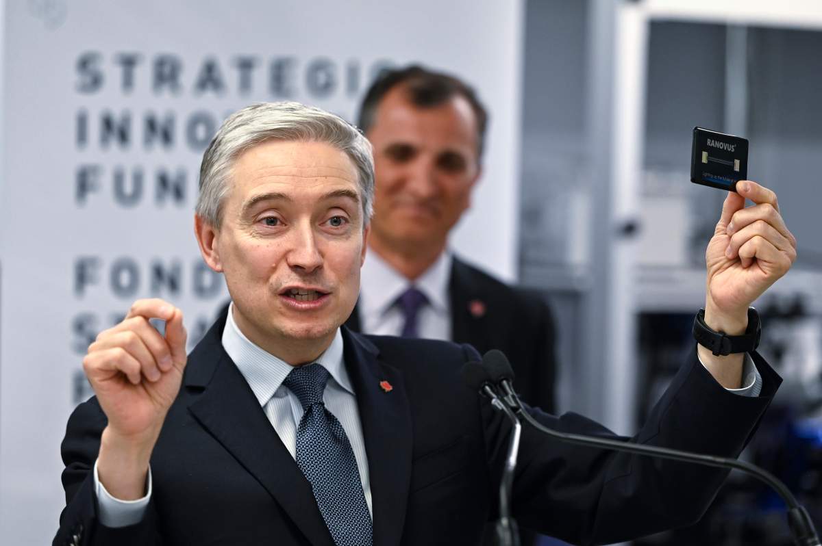 Minister of Innovation, Science and Industry Francois-Philippe Champagne holds up an example of a Ranovus monolithically integrated chip as he speaks during an announcement at Ranovus, a Kanata, Ont.-based producer of semiconductors, in Ottawa, on Monday, March 27, 2023.