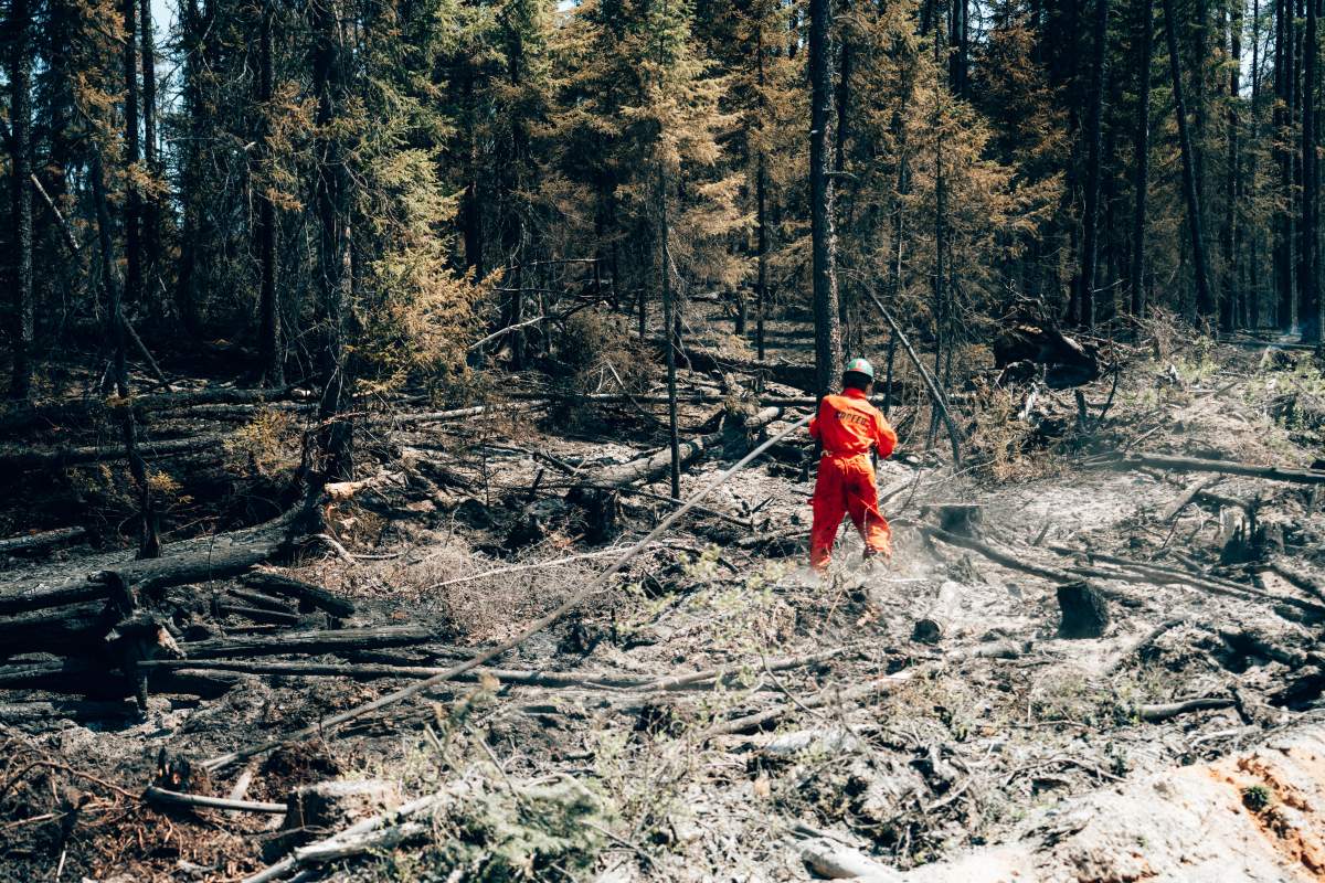 A fire fighter works near Chapais, in Northern Quebec, on Friday June 2, 2023 in this image provided by the fire prevention agency known as SOPFEU.